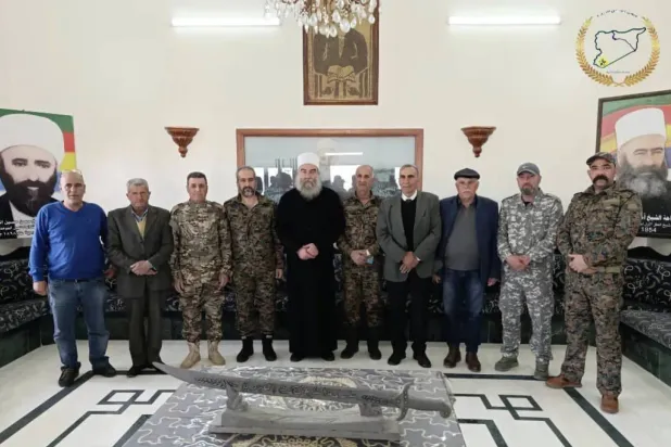 Sheikh Hikmat al-Hijri with members of the “military council” in Sweida. (File photo) 