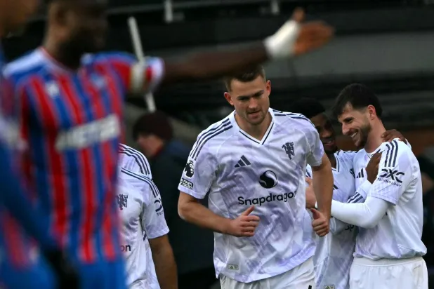 Manchester United's English midfielder #07 Mason Mount (R) celebrates scoring the team's second goal during the English Premier League football match between Crystal Palace and Manchester United at Selhurst Park in south London on November 30, 2025. (AFP)
