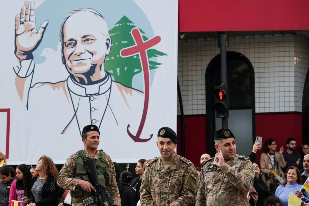 Crowds gather while security personnel stand guard, as Pope Leo XIV visits the country during his first apostolic journey, in Jal el-Dib, Lebanon December 2, 2025. REUTERS/Raghed Waked