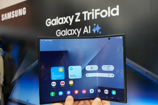 A model shows a Samsung Galaxy Z TriFold smartphone during a launch event at a Samsung store in Seoul, South Korea, Tuesday, Dec. 2, 2025. (AP Photo/Ahn Young-joon)