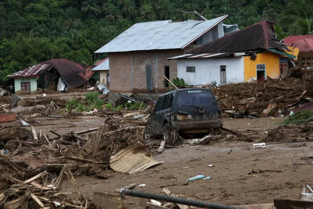A car stuck in the mud sits among debris at an area hit by deadly flash floods following heavy rains in Palembayan, Agam regency, West Sumatra province, Indonesia, December 2, 2025. REUTERS/Willy Kurniawan