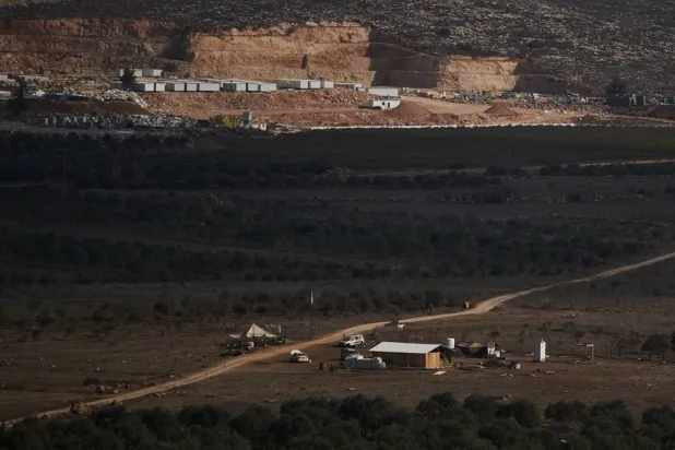 An Israeli settler outpost stands in the middle of a valley next to olive trees in the West Bank town of Turmus Ayya, Wednesday, Nov. 12, 2025. (AP) 