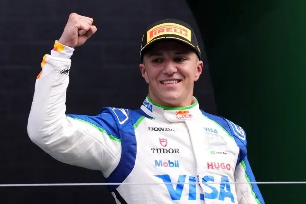 1 August 2025, Netherlands, Zandvoort: French Formula One driver Isack Hadjar of Racing Bulls team celebrates on the podium after taking third place following the Dutch Grand Prix at Circuit Zandvoort. (dpa)