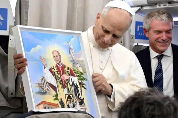 Pope Leo XIV speaks to journalists aboard a flight to Rome at the end of his apostolic journey to Türkiye and Lebanon, on December 2, 2025. (AFP) 