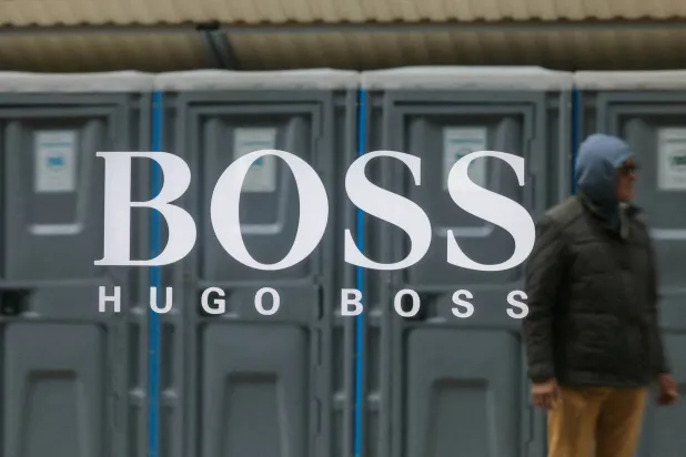 FILE PHOTO: Plastic toilet cabins are reflected in a window with the logo of Hugo Boss fashion company in central Moscow, Russia, May 8, 2025. REUTERS/Maxim Shemetov/File Photo/File Photo