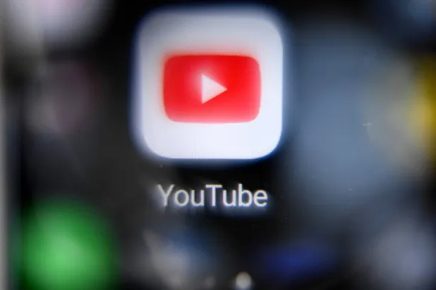 This picture taken in Moscow on October 12, 2021 shows the YouTube logo on a smartphone screen. (AFP) 