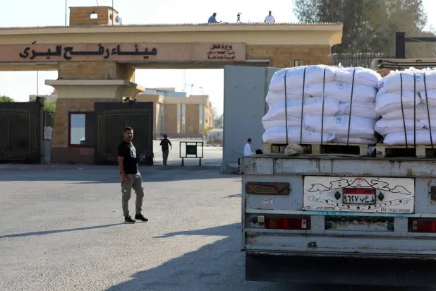 (FILES) A truck loaded with humanitarian aid awaits permission on the Egyptian side of the Rafah crossing with the Gaza Strip, to drive toward the besieged Palestinians territory on July 27, 2025. (Photo by AFP)