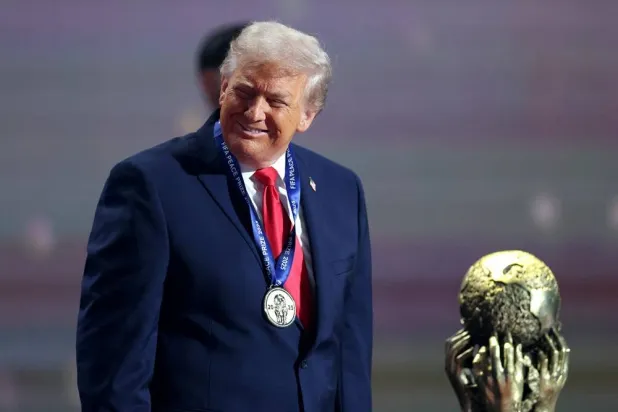 Football - FIFA World Cup 2026 - FIFA World Cup 2026 Draw - John F. Kennedy Center for the Performing Arts, Washington, DC, US - December 5, 2025 US President Donald Trump wears his medal as he is awarded the FIFA Peace Prize. (Reuters)
