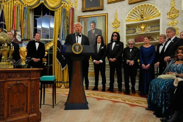  President Donald Trump, center, speaks as he presents Sylvester Stallone, George Strait, Kiss, Gloria Gaynor and Michael Crawford with their Kennedy Center Honors medals in the Oval Office of the White House, Saturday, Dec. 6, 2025, in Washington. (AP) 