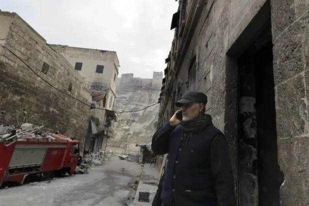 Iran's General Qassem Soleimani makes a phone call near the historic Citadel of Aleppo, winter 2016. (Fars) 