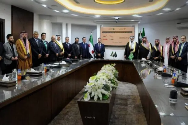 Saudi and Syrian officials are seen at Tuesday's signing ceremony. (SANA)
