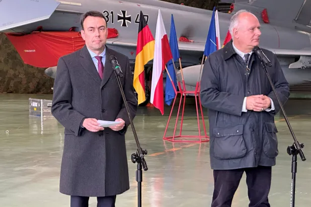 يقف نيلز شميد السكرتير البرلماني لوزير الدفاع الاتحادي مع وزير الدولة البولندي للدفاع باويل زاليفسكي أمام طائرة يوروفايتر (د.ب.أ)
