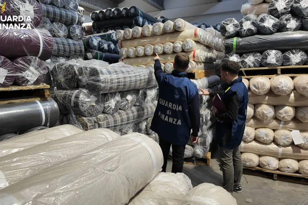 Italian Guardia di Finanza (Tax Police) carry out a search at a textile firm during an investigation, in the Tuscan city of Prato, Italy, in this handout photo obtained by Reuters. Guardia di Finanza Press Office/Handout via REUTERS