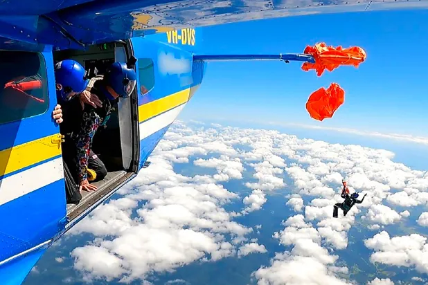 This frame grab taken from undated video footage provided by the Australian Transport Safety Bureau on December 11, 2025 shows the moment a skydiver was left dangling thousands of meters in the air after their parachute caught on the plane's tail. (Photo by Handout / AUSTRALIAN TRANSPORT SAFETY BUREAU / AFP) 