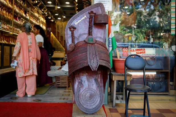 FILE PHOTO: Customers shop for 'Kolhapuri' sandals, an Indian ethnic footwear, at a store in New Delhi, India, June 27, 2025. REUTERS/Adnan Abidi/File Photo