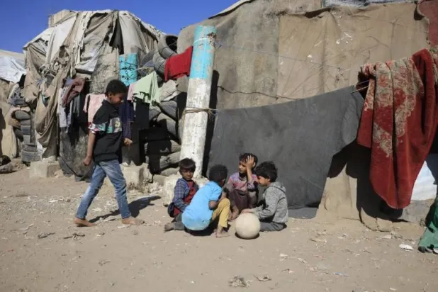 Displaced children gather in a camp in Sanaa. EPA