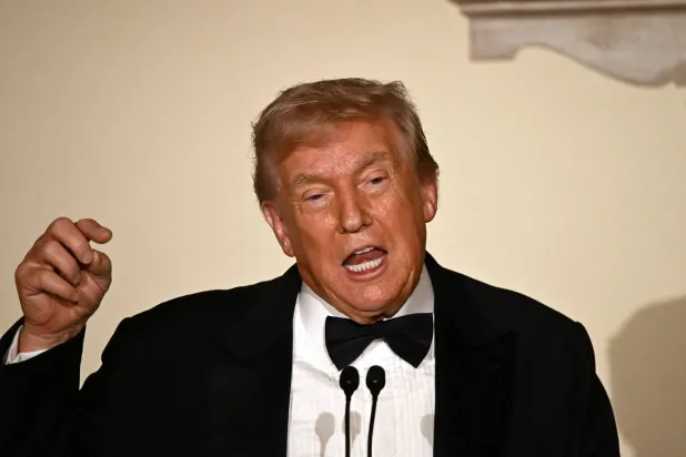 US President Donald Trump delivers remarks during the Congressional Ball in the Grand Foyer of the White House in Washington, DC, on December 11, 2025. (Photo by Alex WROBLEWSKI / AFP)