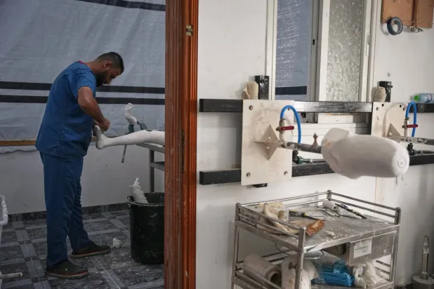 Prosthetic limb technician Ahmed Al-Ashqar, 34, prepares a leg amputation splint in the first stage of building an artificial leg at Hamad Hospital in Zawaida, central Gaza Strip, Thursday, Nov. 27, 2025. (AP Photo/Abdel Kareem Hana)
