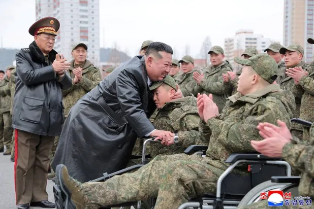 North Korean leader Kim Jong Un embraces a soldier during a welcoming ceremony for members of the 528th Engineer Regiment after they returned from an overseas mission, at the April 25 Cultural and Tourism Center in Pyongyang, North Korea, December 12, 2025, in this picture released by North Korea's official Korean Central News Agency on December 13, 2025. (KCNA via Reuters) 