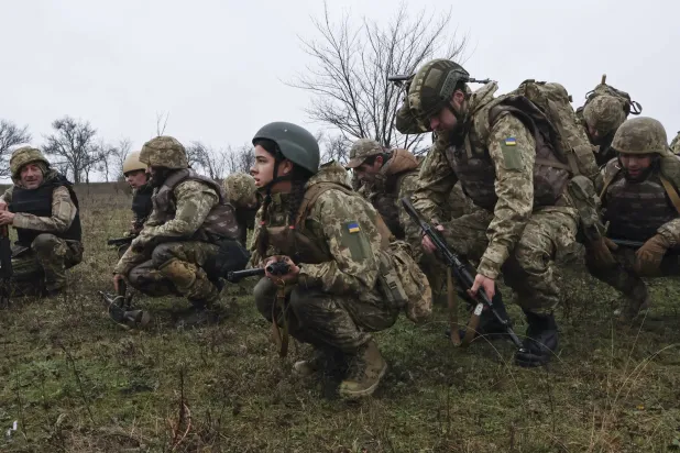 A handout photo made available by the press service of the 65th Separate Mechanized Brigade of the Ukrainian Armed Forces shows the recruits who take part in the short and intense march during their basic military training (BMT) in an undisclosed location in the Zaporizhzhia area, Ukraine, 12 December 2025, amid the ongoing Russian invasion. EPA/Press service of the 65th Mechanized Brigade HANDOUT 