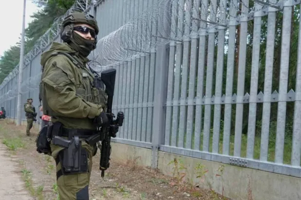 A border guard officer stands guard at the Polish-Belarusian border, in Polowce, Poland. (AP file photo)