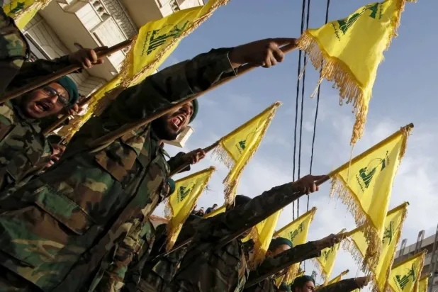 Lebanon’s Hezbollah members carry Hezbollah flags during the funeral of a fellow fighter, in al-Ghaziyeh village, southern Lebanon May 26, 2015. REUTERS/Ali Hashisho