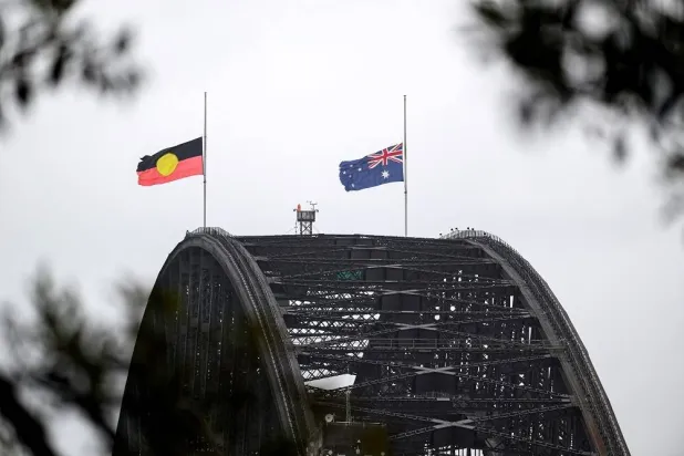 Flags fly at half-mast on the Sydney Harbor Bridge in Sydney, Australia, December 15, 2025. (AAP/Steven Markham via Reuters) 
