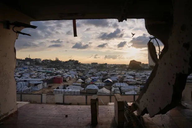 Seen from a building heavily damaged during the Israeli air and ground operations, tents fill a makeshift camp for displaced Palestinians in Deir al-Balah, central Gaza Strip, Saturday, Dec. 13, 2025. (AP)