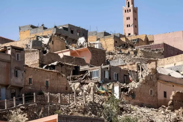 The minaret of a mosque stands behind damaged or destroyed houses following an earthquake in Moulay Brahim, Al-Haouz province, on September 9, 2023. (AFP)
