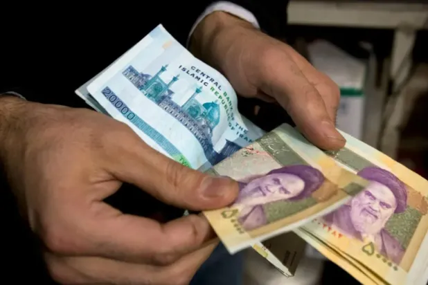 An Iranian trader counts money in Tehran's Grand Bazaar. (Reuters)

