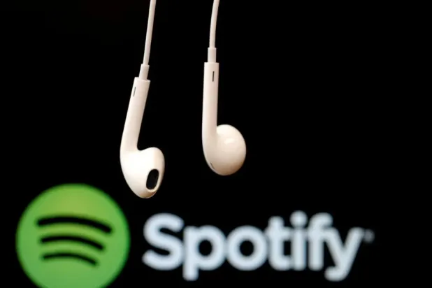 FILE PHOTO: Headphones are seen in front of a logo of online music streaming service Spotify, February 18, 2014 REUTERS/Christian Hartmann/File Photo
