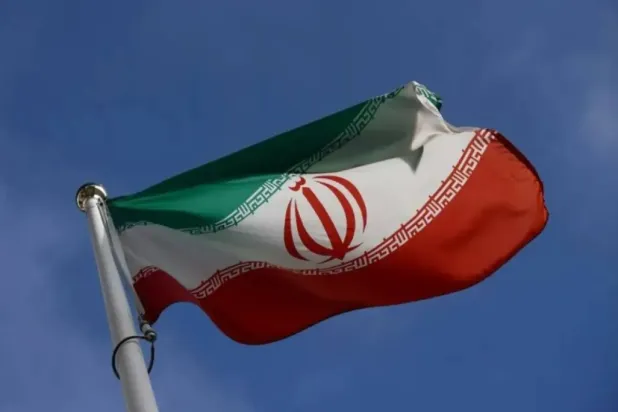 The Iranian flag waves in front of the International Atomic Energy Agency (IAEA) headquarters, before the beginning of a board of governors meeting, amid the coronavirus disease (COVID-19) outbreak in Vienna, Austria, March 1, 2021. (Reuters)
