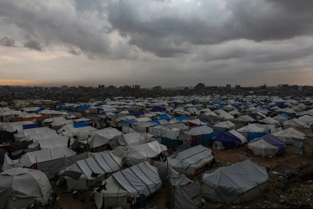 Tents of internally displaced Palestinian families seen among the ruins of destroyed buildings in Al-Zaitun neighborhood during a rainy day in the east of Gaza City on, 12 December 2025, amid a ceasefire between Israel and Hamas. (EPA)