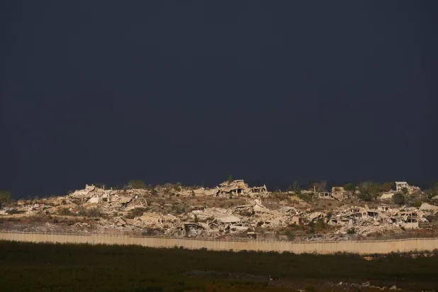  UN vehicles drive past buildings destroyed by Israel's air and ground offensive against Hezbollah in southern Lebanon, as seen from Israel's northernmost town of Metula, Sunday, Nov. 30, 2025. (AP) 