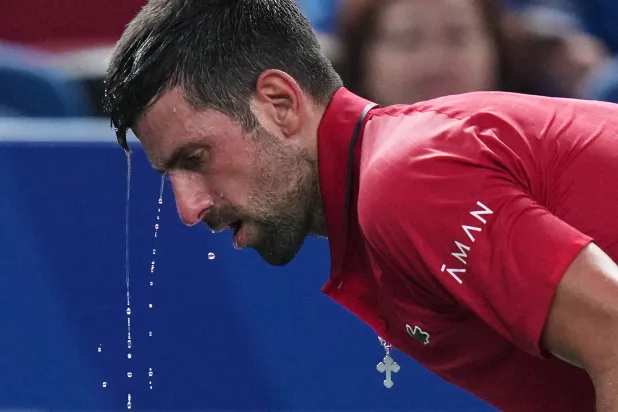 Novak Djokovic of Serbia cools himself with water during the men's singles semifinal match with Valentin Vacherot of Monaco, at the Shanghai Masters tennis tournament at Qizhong Forest Sports City Tennis Center, in Shanghai, China, Saturday, Oct. 11, 2025. (AP)