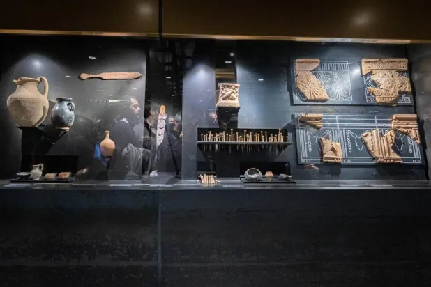 People examine artifacts on display during the inauguration of the Colosseo Fori Imperiali stop on Metro Line C in Rome, Italy, 16 December 2025. (EPA)