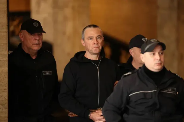 Igor Grechushkin, a Russian businessman based in Cyprus, is escorted by police before the start of his trial on the possible extradition to Lebanon, in Sofia, Bulgaria, December 10, 2025. (Reuters)