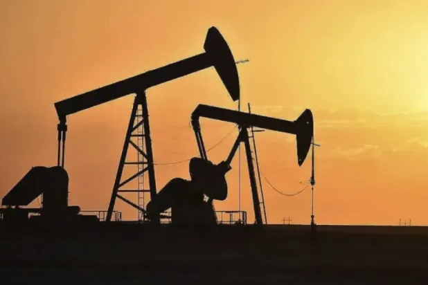 FILE - Pump jacks extract oil from beneath the ground in North Dakota, May 19, 2021. (AP Photo/Matthew Brown, File)
