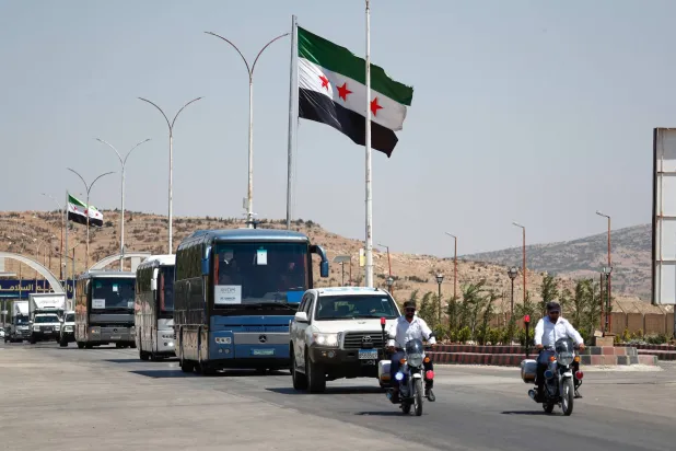FILE - A convoy of buses carry Syrian refugees who return home from Lebanon, arrive at the Syrian border crossing point, in Jdeidet Yabous, Syria, Tuesday, July 29, 2025. (AP Photo/Omar Sanadiki, File)