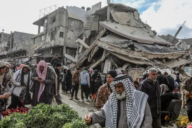 Palestinians shop amid the rubble in Khan Younis in southern Gaza, February last year (DPA)