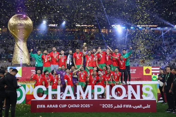 Morocco's players celebrate with the winner trophy after defeating Jordan in the FIFA Arab Cup final soccer match in Lusail, Qatar, Thursday, Dec. 18, 2025. (AP Photo/Hussein Sayed)