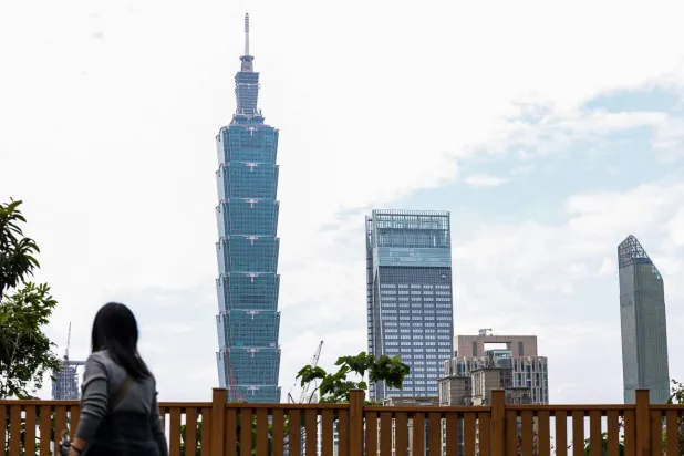 The Taipei 101 building is seen among residential and commercial buildings in Taipei on December 18, 2025. (Photo by I-Hwa Cheng / AFP)