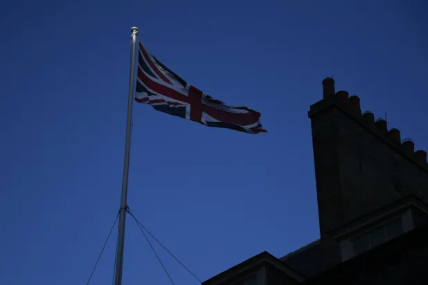 FILE - In this file photo dated Monday, Dec. 14, 2020, the Union Flag flies on the top of 10 Downing Street, the Prime Minister's official residence in London. (AP Photo/Alberto Pezzali, FILE)