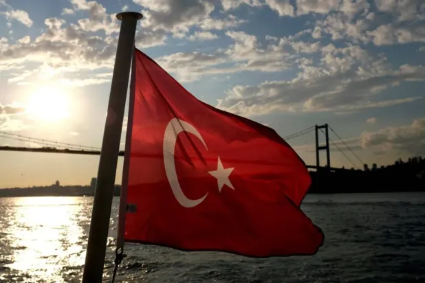 A Turkish flag with the Bosphorus Bridge in the background, flies on a passenger ferry in Istanbul, Türkiye September 30, 2020. (Reuters)

