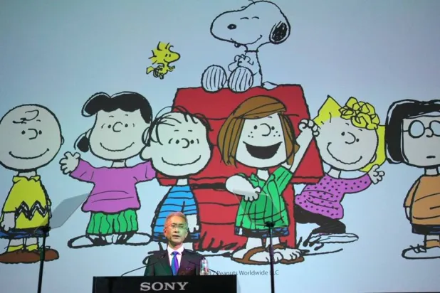 Sony Corp. President Kenichiro Yoshida speaks as characters from "Peanuts" are shown at a press conference at the company's headquarters Tuesday, May 22, 2018, in Tokyo. (AP)
