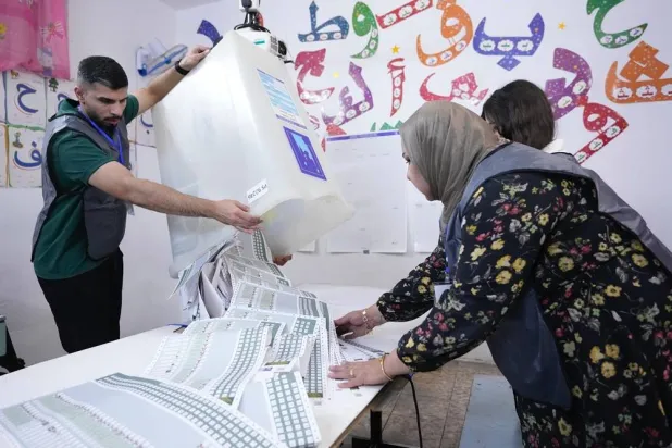 Election workers count ballots as they close a polling station, during the parliamentary elections in Baghdad, Iraq, Nov. 11, 2025. (AP) 
