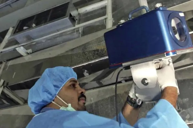 An inspector of the International Atomic Energy Agency sets up surveillance equipment at a uranium conversion facility in Iran in 2005. Photograph: Mehdi Ghasemi/AP