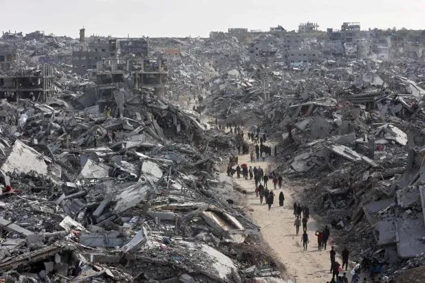 (FILES) This aerial view shows displaced Palestinians returning to the war-devastated Jabalia refugee camp in the northern Gaza Strip on January 19, 2025, shortly before a ceasefire deal in the war between Israel and Hamas was implemented. (Photo by Omar AL-QATTAA / AFP)