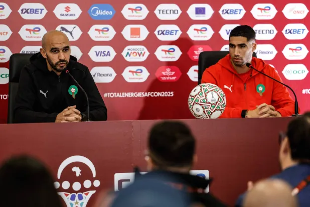 Morocco's head coach Walid Regragui and Morocco's defender #02 Achraf Hakimi attend a press conference at Prince Moulay Abdellah Stadium in Rabat, Morocco on December 20, 2025, ahead of the start of the Africa Cup of Nations (CAN) football tournament. (Photo by Abdel Majid BZIOUAT / AFP)