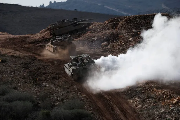 FILE PHOTO: Israeli military vehicles manoeuvre along the Israel-Lebanon border, as seen from northern Israel, November 24, 2025. REUTERS/Shir Torem/File Photo